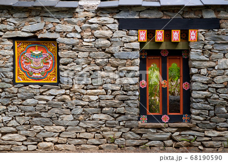 Colorful Tibetan window on the rock wall in Tibet, China 68190590