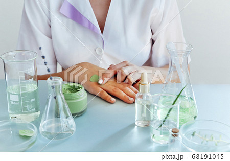 Woman examining green plant in laboratory, close 68191045