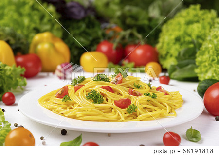 Plate of italian pasta, spaghetti with tomatoes and basil leaves Plate of italian pasta, spaghetti with tomatoes and basil leaves 68191818