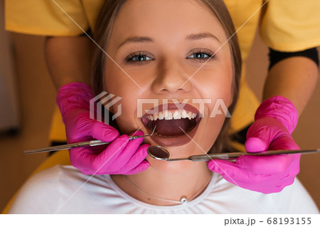 Beautiful young blonde women at dentist for examination 68193155