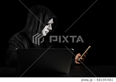 hacker in black hooded, white mask use computer and mobile phone, break security data server. hacker in black hooded, white mask use computer and mobile phone, break security data server. 68195481