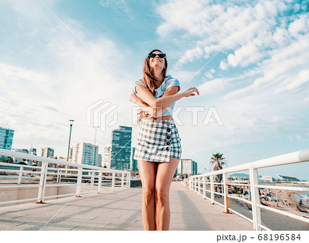 woman in sexy stylish clothes posing in the modern city with skyscrapers on background woman in sexy stylish clothes posing in the modern city with skyscrapers on background 68196584