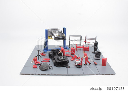 a Mini mechanics repairing toy car,concept of the 68197123