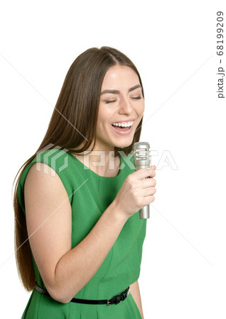 Happy young woman with microphone on white background 68199209