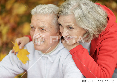 Portrait of smiling senior couple in autumn park Portrait of smiling senior couple in autumn park 68199317