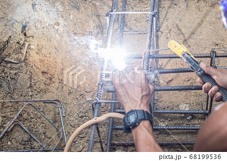 Worker welding steel structure at construction 68199536