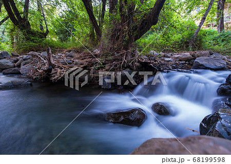 Pure water stream with smooth flow over rocky Pure water stream with smooth flow over rocky 68199598