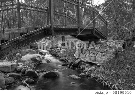 Bridge over smooth flowing water stream at the Bridge over smooth flowing water stream at the 68199610