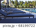 Sun beds by the pool in the open air. Pool at the spa resort. 68199722
