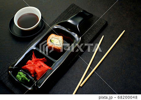 Sushi rolls top view. Stylish minimalism in the menu. Serving rolls to the client in a dark style.  68200048