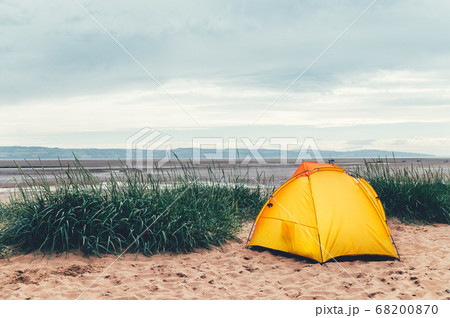 Bright Yellow Tent on the Beach 68200870