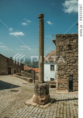 Stone pillory in front of old stone houses at Monsanto 68202087
