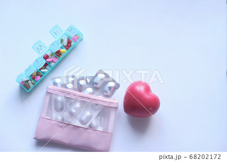 top view of blister pack, heart symbol and pill box on white background top view of blister pack, heart symbol and pill box on white background 68202172