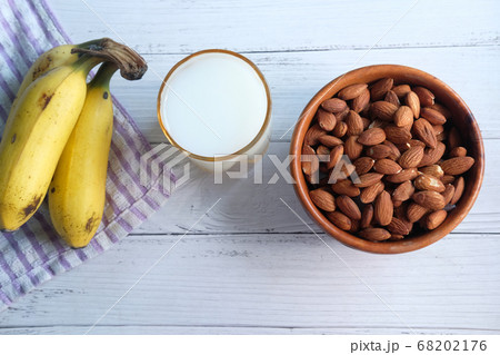 almond nut, milk and banana on table  68202176