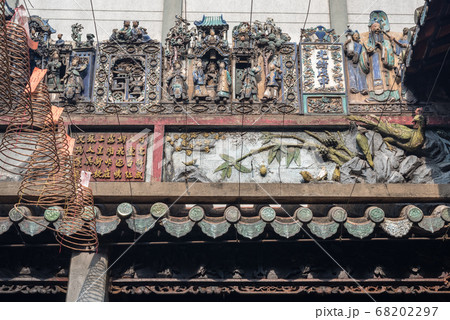 Composition of figurines showing a crowded city scene on the roof of Thien Hau Temple (erected in c. 1760), one of the top tourist attractions of Cho Lon ("Chinatown"), Ho Chi Minh City, Vietnam. 68202297