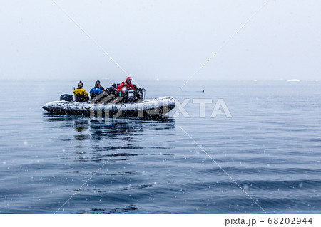 Snowfall over the Zodiac boat with frozen polar Snowfall over the Zodiac boat with frozen polar 68202944