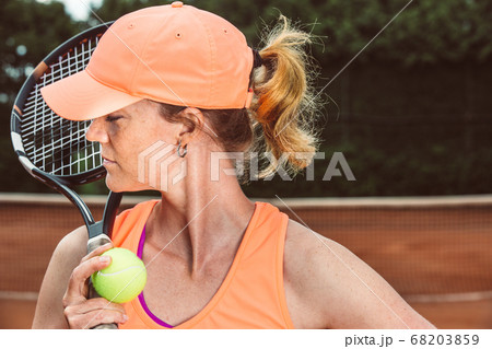 Professional tennis woman player in an action playing tennis in tennis court outdoor, sport concept, copyspace Professional tennis woman player in an action playing tennis in tennis court outdoor, sport concept, copyspace 68203859