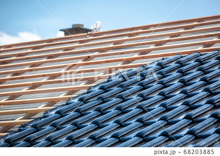 Black roof of burnt tiles under the construction, roof paver Black roof of burnt tiles under the construction, roof paver 68203885