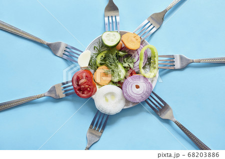 Sliced pieces of fresh vegetables on the forks 68203886