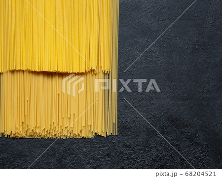 Dry spaghetti close up on a black background Dry spaghetti close up on a black background 68204521