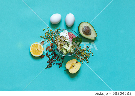 Set for a healthy balanced snack with Munga bean sprouts, avocado and tofu on an aquamarine background Set for a healthy balanced snack with Munga bean sprouts, avocado and tofu on an aquamarine background 68204532