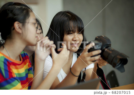 asian teenager looking on back screen of dslr asian teenager looking on back screen of dslr 68207015