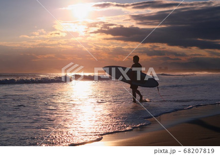空と海と砂浜 そして人のシルエットがきれいです の写真素材