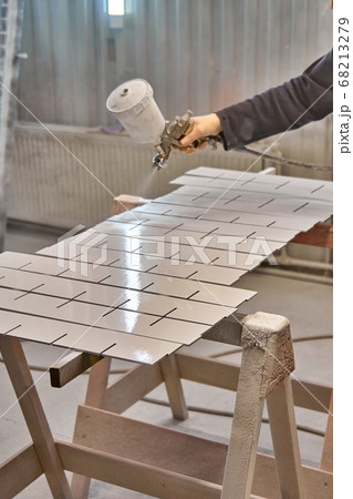 Painting furniture in a spray booth. Furniture manufacturing Painting furniture in a spray booth. Furniture manufacturing 68213279
