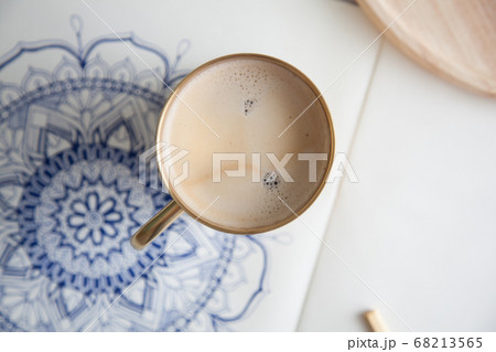 Decorative round floral mandala drawn on a white sheet. Home relaxation, hobby and rest. Coffee and cookies on a white background. 68213565