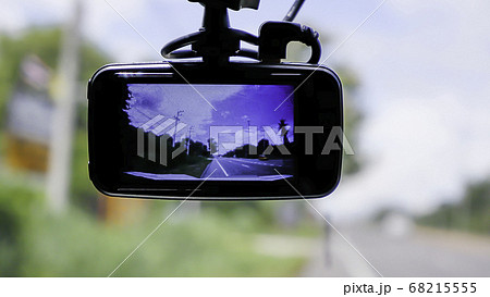 Camera on the front of a car  Background Cars on the road and clouds in the sky. 68215555