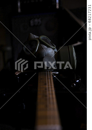 Military Gas Mask on a electric guitar in dark ambient. Coronavirus, Covid19 pandemic prevention Military Gas Mask on a electric guitar in dark ambient. Coronavirus, Covid19 pandemic prevention 68217231