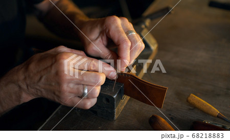 Skinner working with leather. Skinner working with leather. 68218883