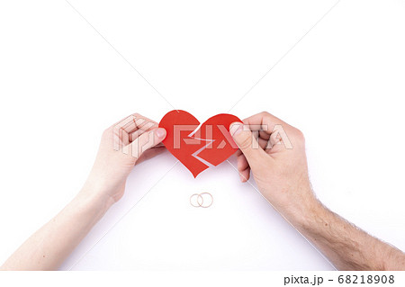 Female and male hands hold a broken heart on a 68218908