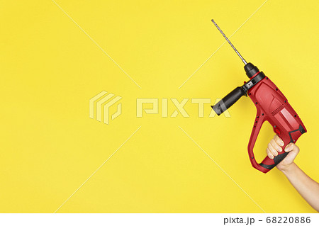 Red Puncher in the hands of a builder. 68220886