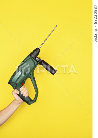 Green Puncher in the hands of a builder. 68220887