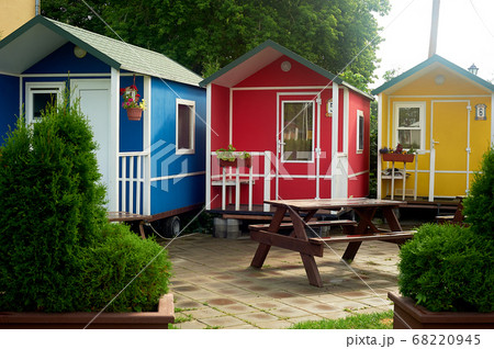 Camping in nature.Small multi-colored houses on wheels. Rest in nature in comfortable conditions. Camping in nature.Small multi-colored houses on wheels. Rest in nature in comfortable conditions. 68220945