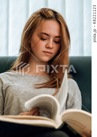 Ginger hair girl with casual clothes reading a Ginger hair girl with casual clothes reading a 68221123