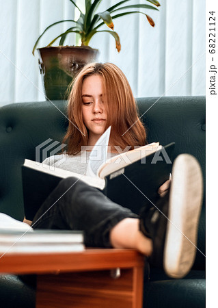 Ginger hair girl with casual clothes reading a Ginger hair girl with casual clothes reading a 68221124