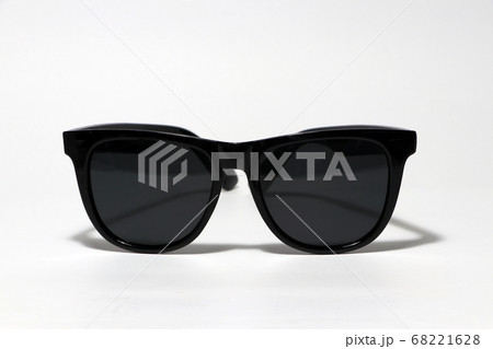Black sunglasses put on the white floor. 68221628