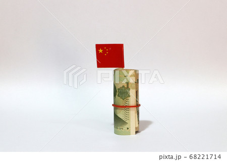Rolled banknote money one Yuan China and stick with mini Chinese flag on white background. Rolled banknote money one Yuan China and stick with mini Chinese flag on white background. 68221714