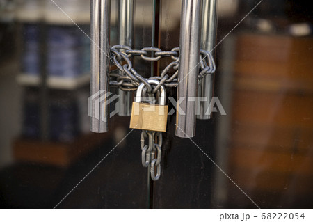 Closed Store due to Coronavirus pandemic. Locked Store Door with Padlock 68222054