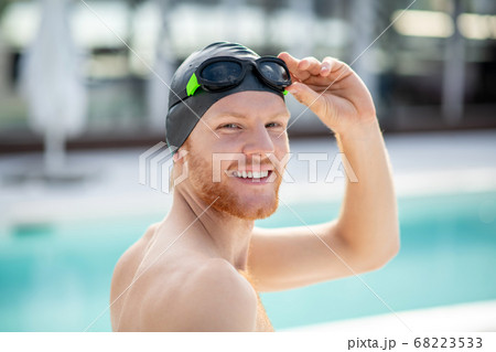 Smiling man turned his head swimmer in swimming cap Smiling man turned his head swimmer in swimming cap 68223533