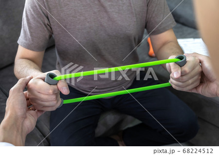 Doctor physiotherapist treating rehabilitation arm 68224512