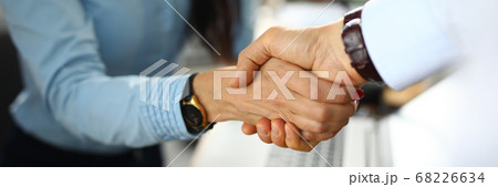 Man and a woman in office shake hands 68226634