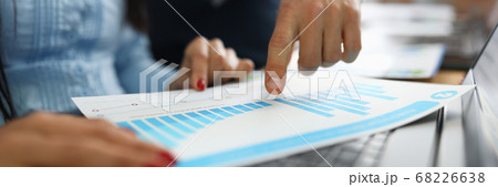 Businessman shows business performance on graph closeup Businessman shows business performance on graph closeup 68226638