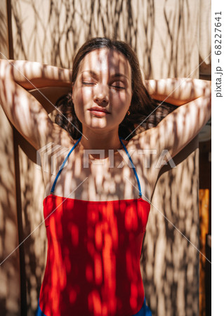 Young woman, sunbathing under shadow of a palm 68227641