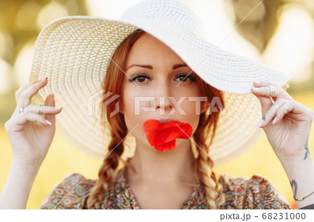 Portrait of beautiful redhead woman in white hat Portrait of beautiful redhead woman in white hat 68231000