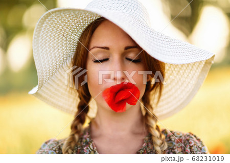 Portrait of beautiful redhead woman in white hat 68231019