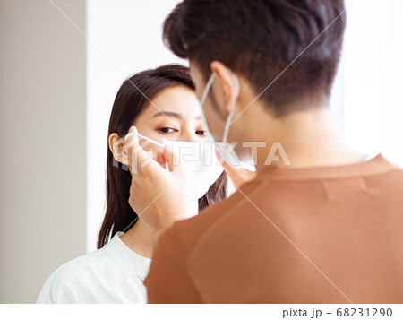 Young asian woman and man wearing Surgical mask to prevent infection at home quarantine 68231290