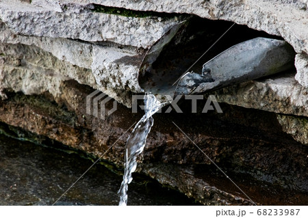 Stream of water in the spring on the stones 68233987